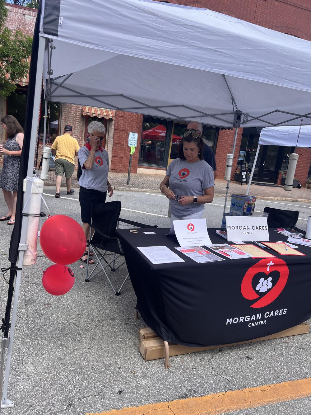 The Morgan Cares Center booth at a street festival in downtown Madison, Georgia.